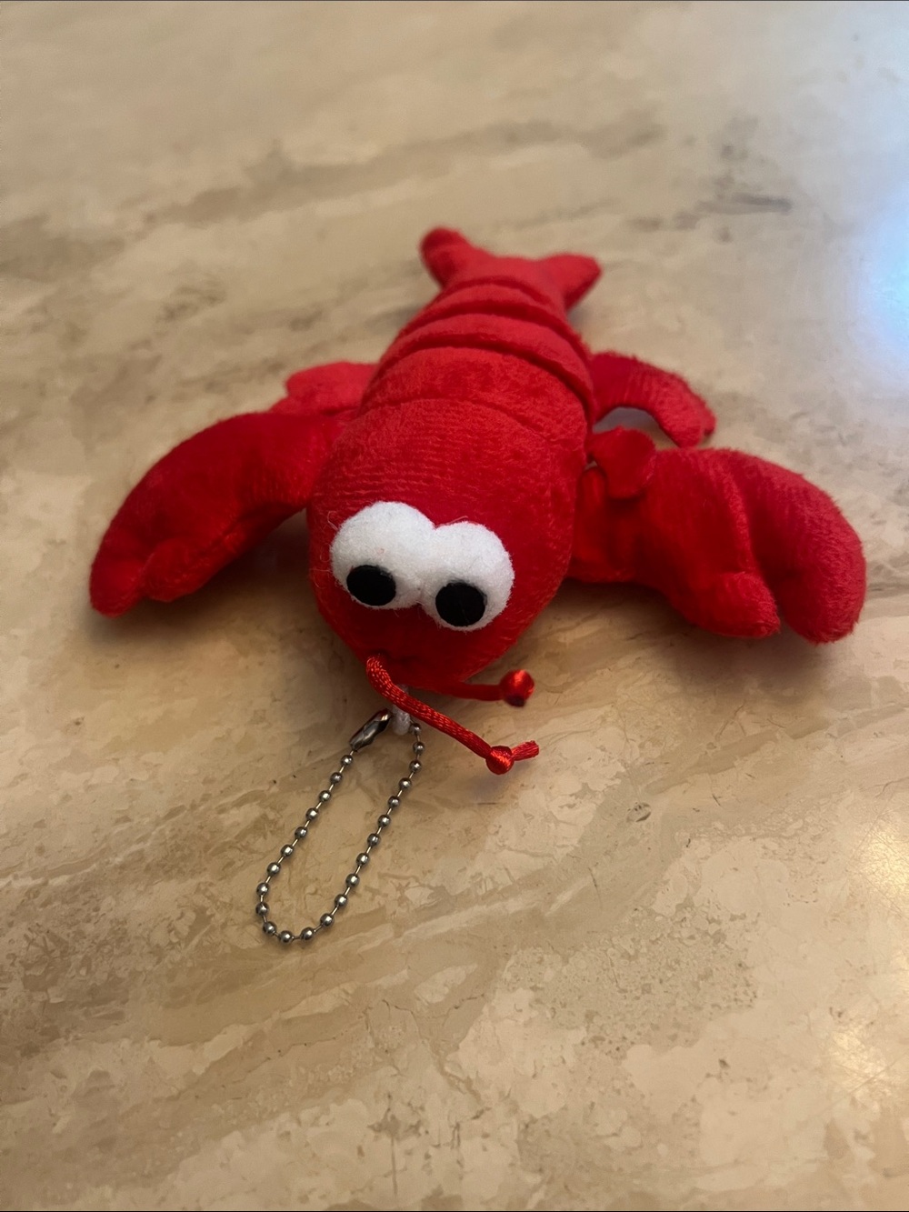 Red plush crawfish or lobster keychain with large white-and-black googly eyes